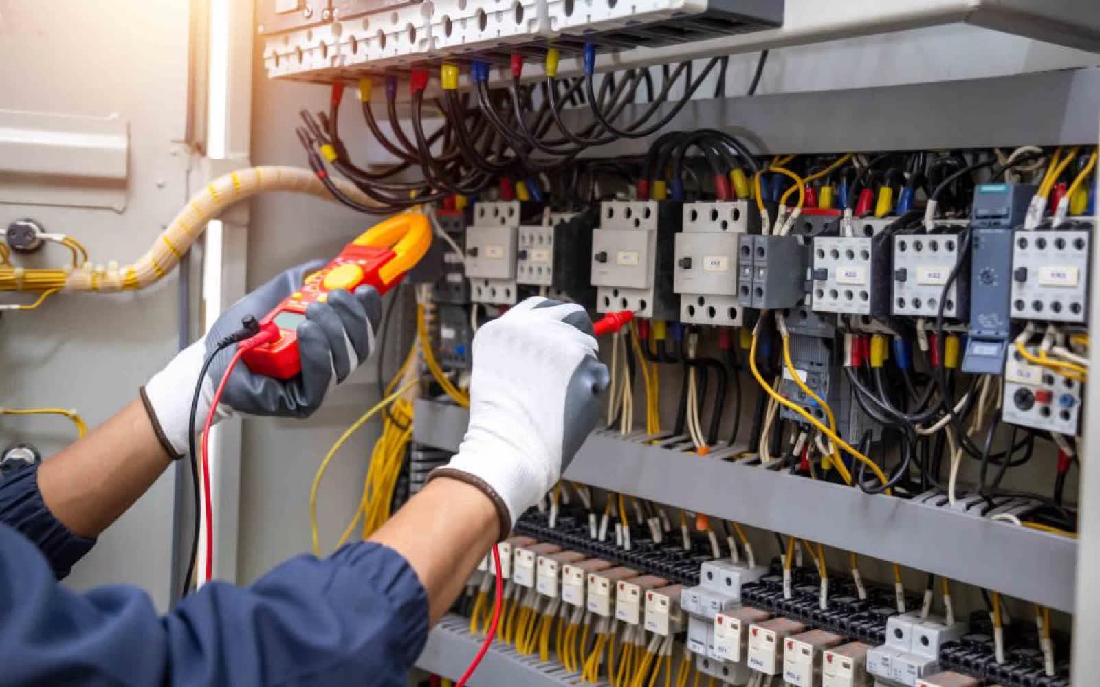 Electrician working in a commercial panel