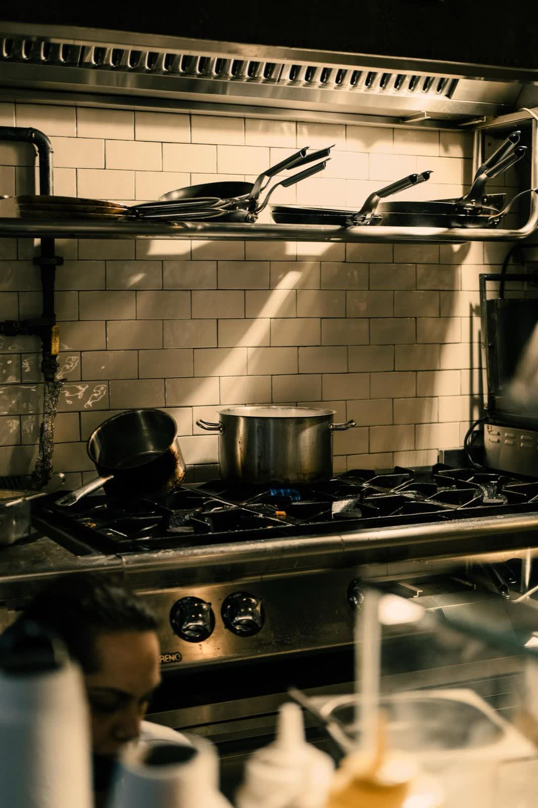 Commercial restaurant stove with pots and pans