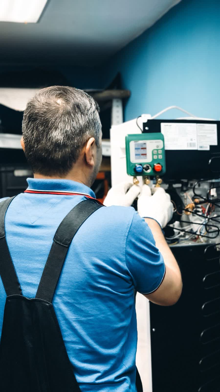 Service technician working on commercial equipment controls