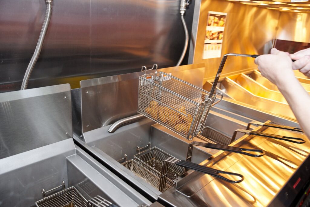 A close up of an open fryer with food inside