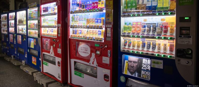 A vending machine with many different drinks on the shelves.