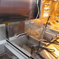 A close up of an open fryer with food inside